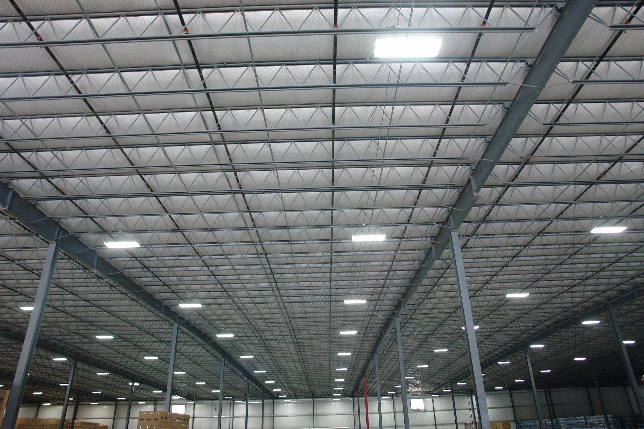 Structural steel framing and insulated metal roof deck in a pre-engineered metal building.